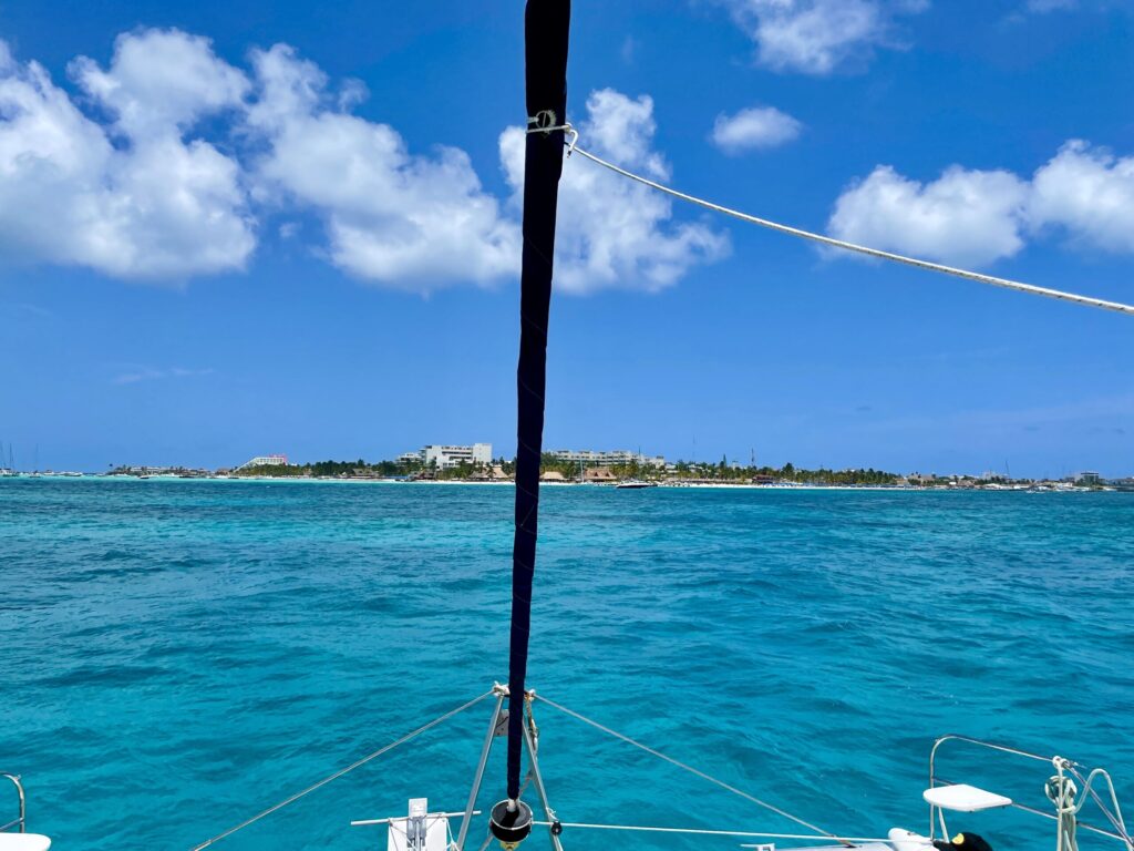 In this picture a catamaran is sailing on the sea from Mexico towards Isla Mujeres